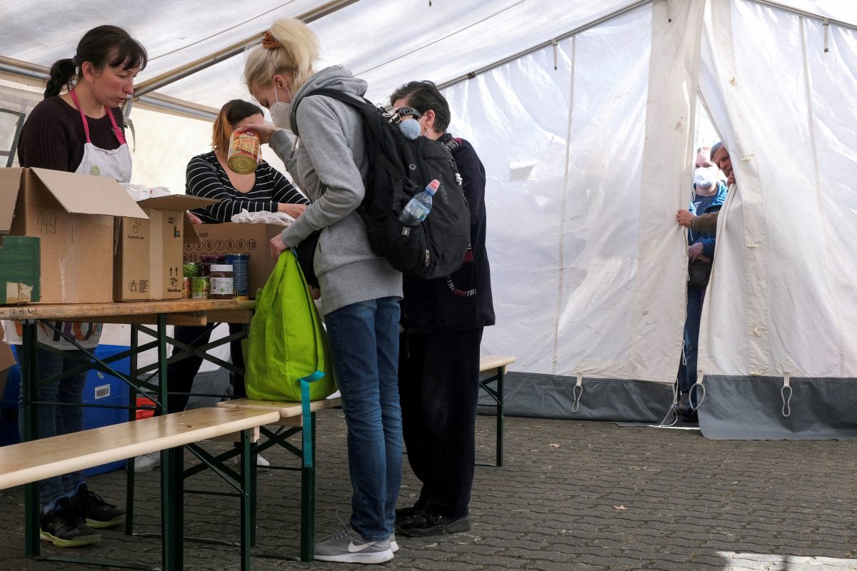Refugees from Ukraine collect food in a tent at a donation collection point organized by Dresden's Ukrainian Catholic parish in Dresden, Germany