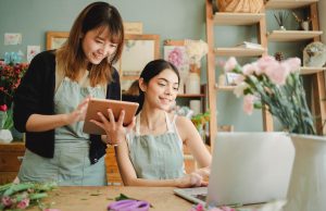 Two happy Amazon sellers, smiling and enjoying their success in the e-commerce business.