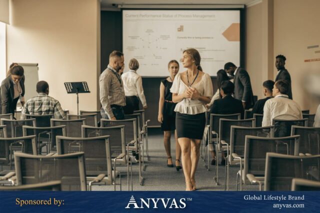 A professional training session with individuals interacting in a modern conference room, featuring a presentation on process management displayed on the screen.