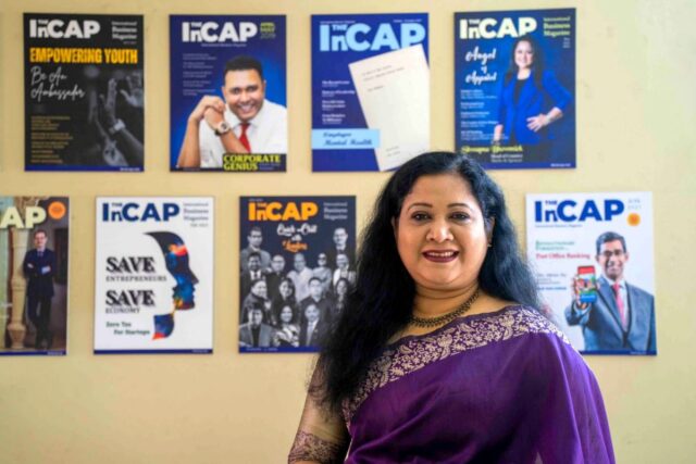 Nasrin Nahar Jeneva, Editor of The InCAP, standing in front of a wall showcasing various cover pages of The InCAP magazine.