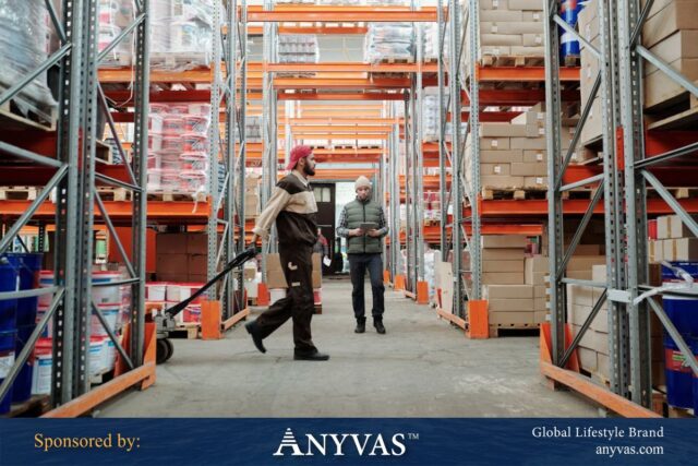 Warehouse workers managing inventory in a modern storage facility with organized shelves, boxes, and materials.