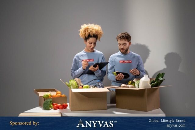 Two volunteers wearing matching blue sweaters with 