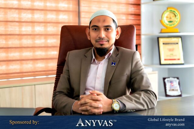 Shah Md. Mohin Uddin sitting confidently in his office chair, exuding leadership and professionalism. Sponsored by ANYVAS.